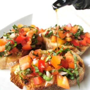 pouring oil on completed bruschetta recipe