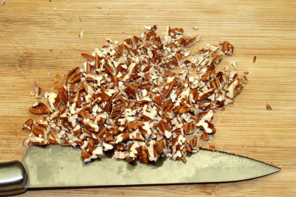 chopped pecans on a board