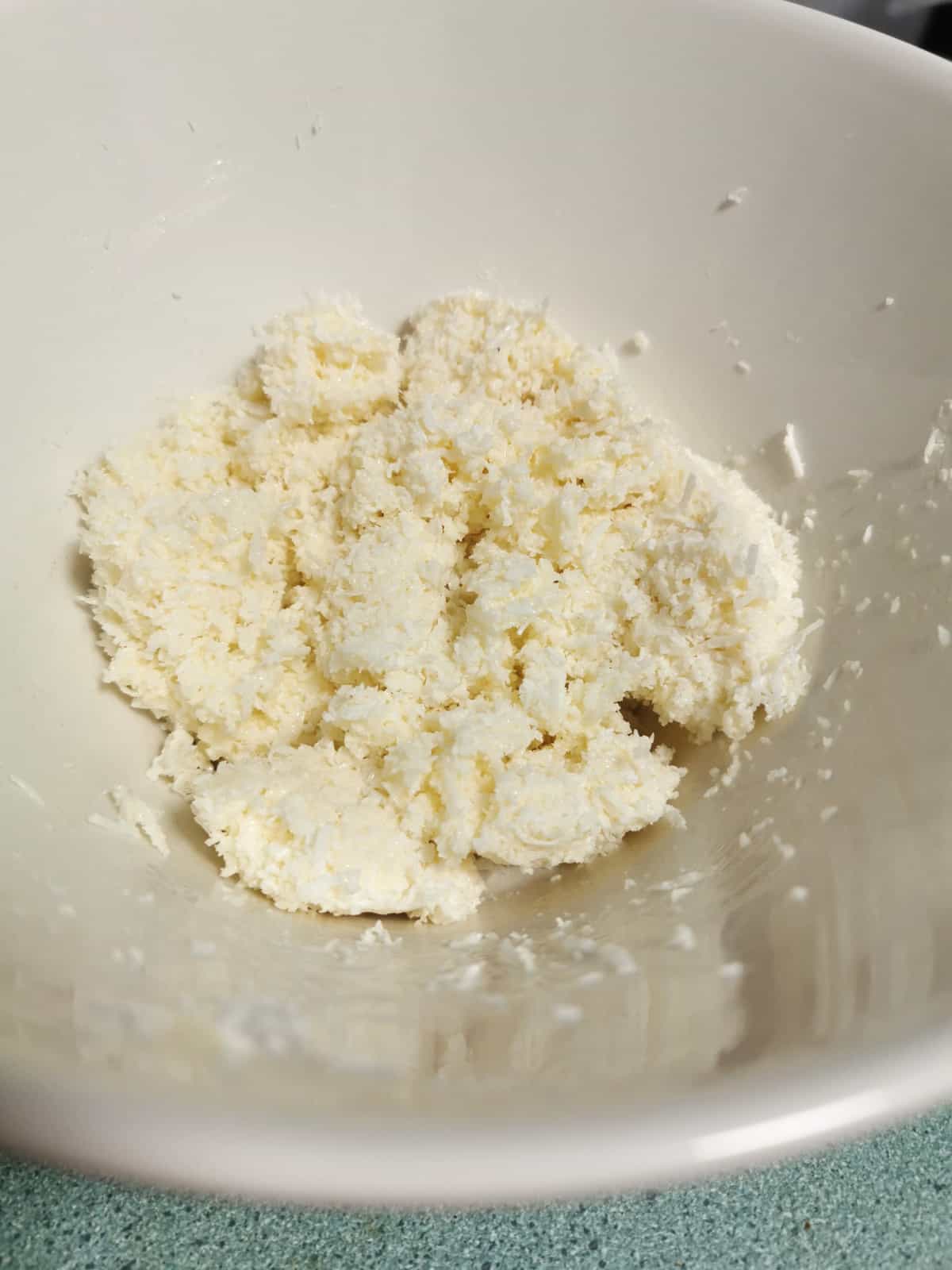 condensed milk and coconut mixed together in a bowl