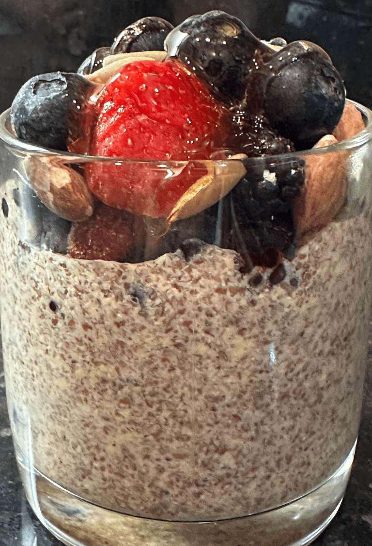 The pudding is served with frozen berrries.