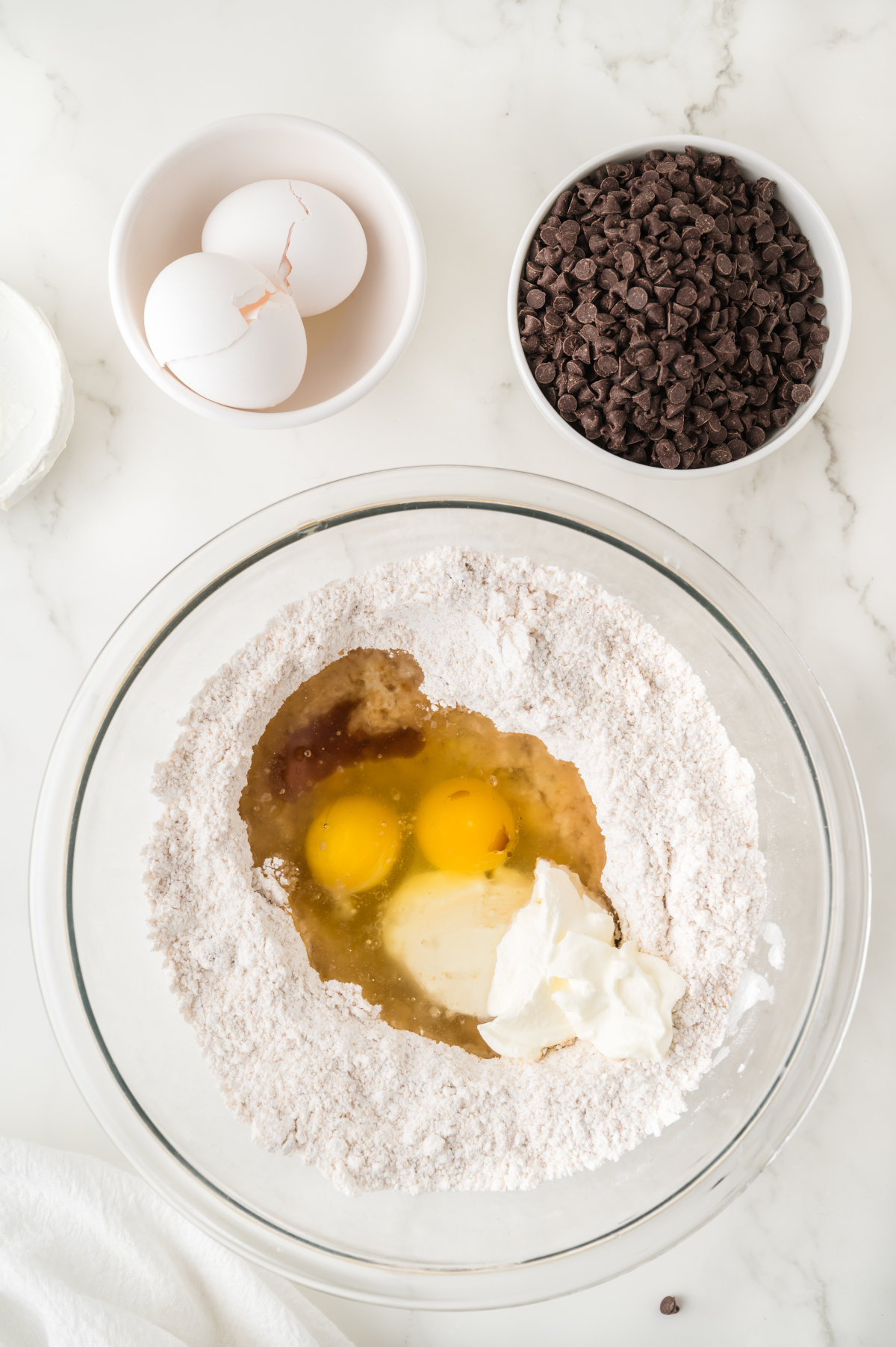 The cake's wet ingredients added into the bowl of dry ingredients, with the chocolate on the side.