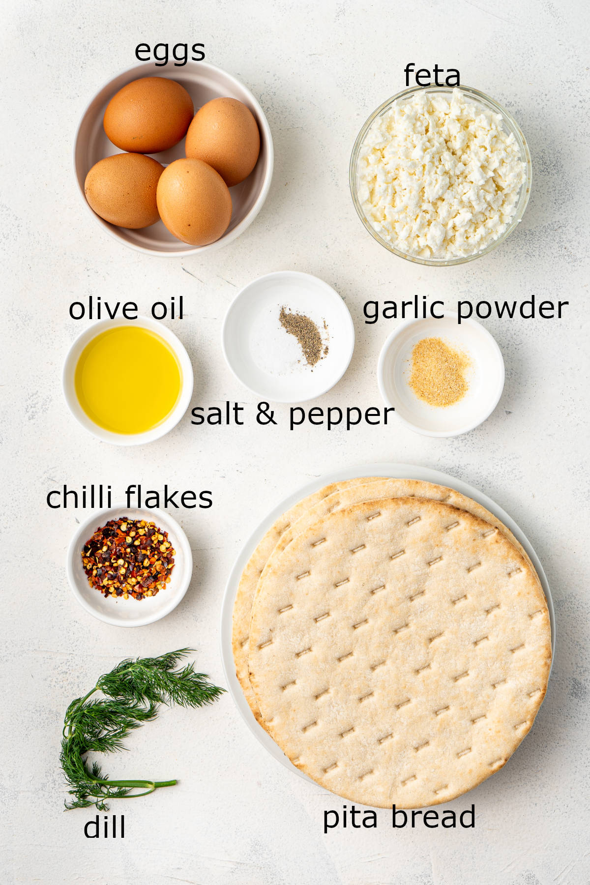 The ingredients for our eggs laid out and labelled on a white countertop