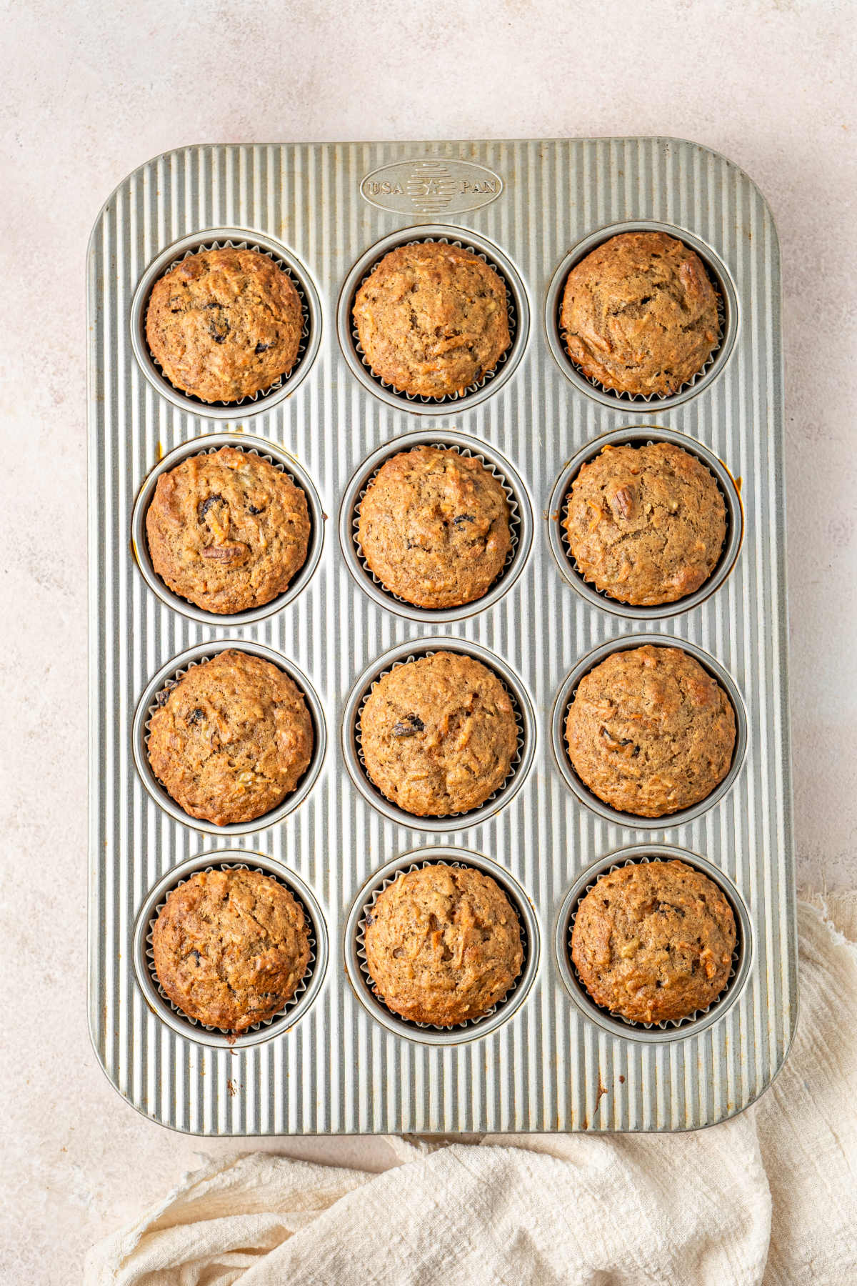 The muffin tray fresh out of the oven, now filled with baked muffins.