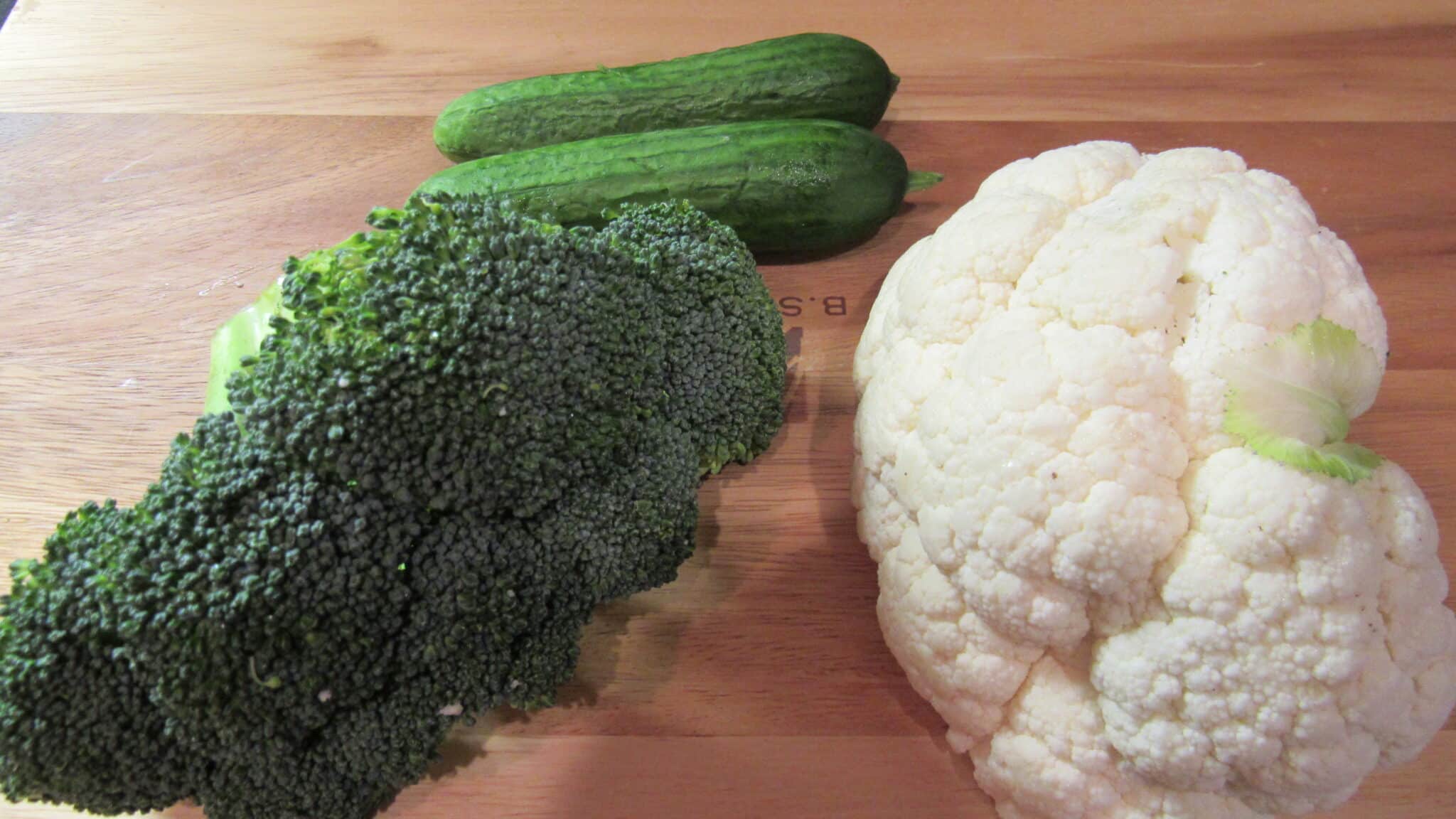 Uncooked broccoli, cauliflower and cucumber.