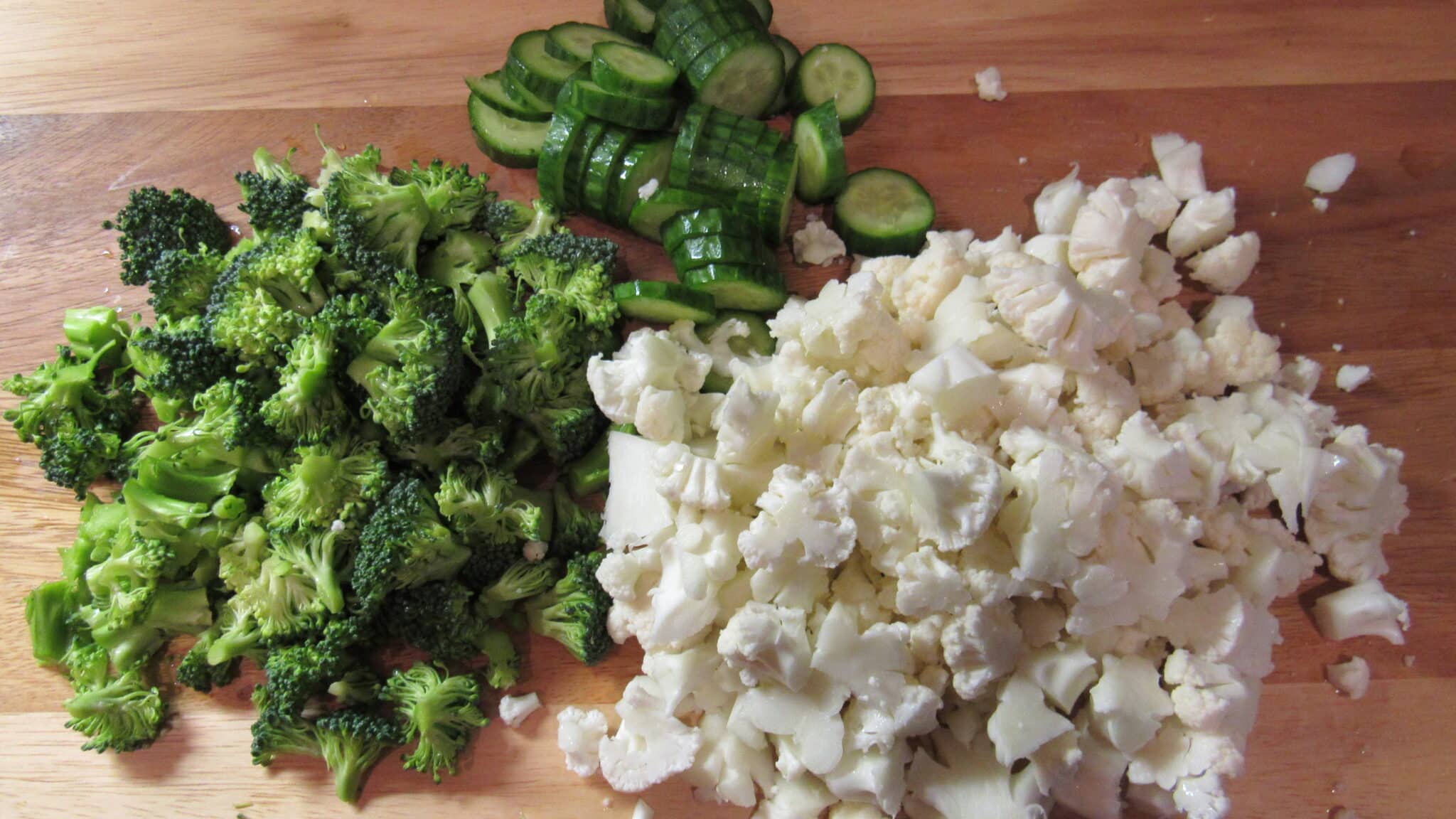 Chopped broccoli, cauliflower and cucumber.