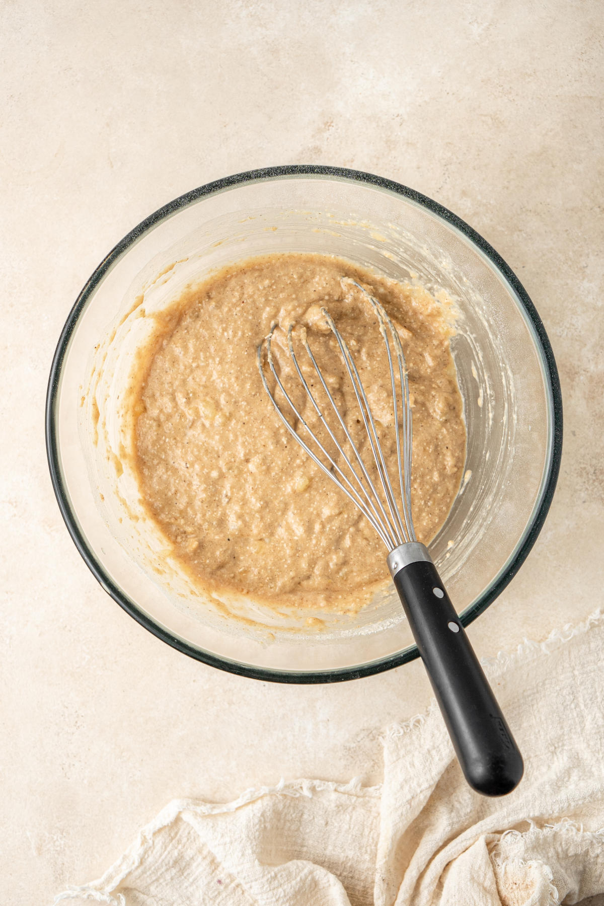 The dry and wet muffin ingredients combined in the mixing bowl with a whisk.