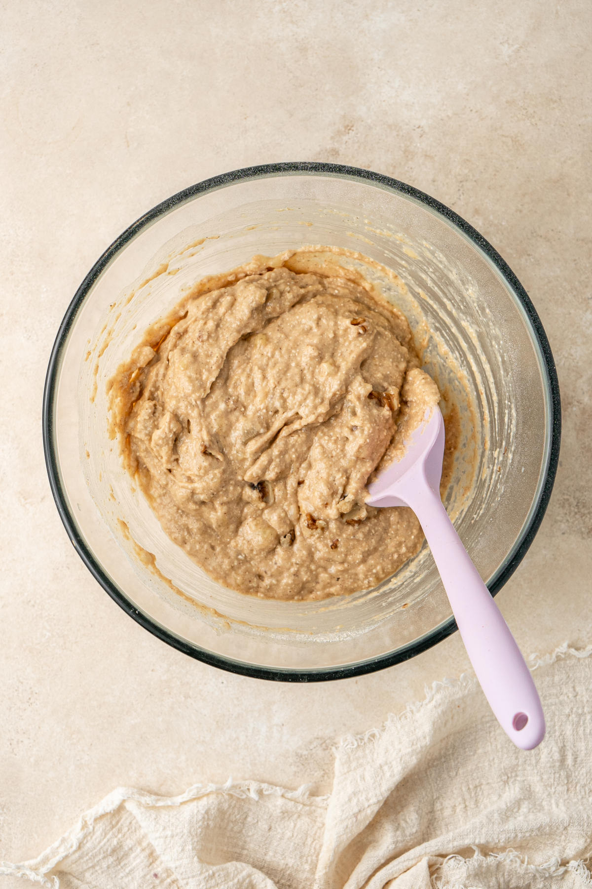 The batter in its bowl with the walnuts folded in by a spatula.