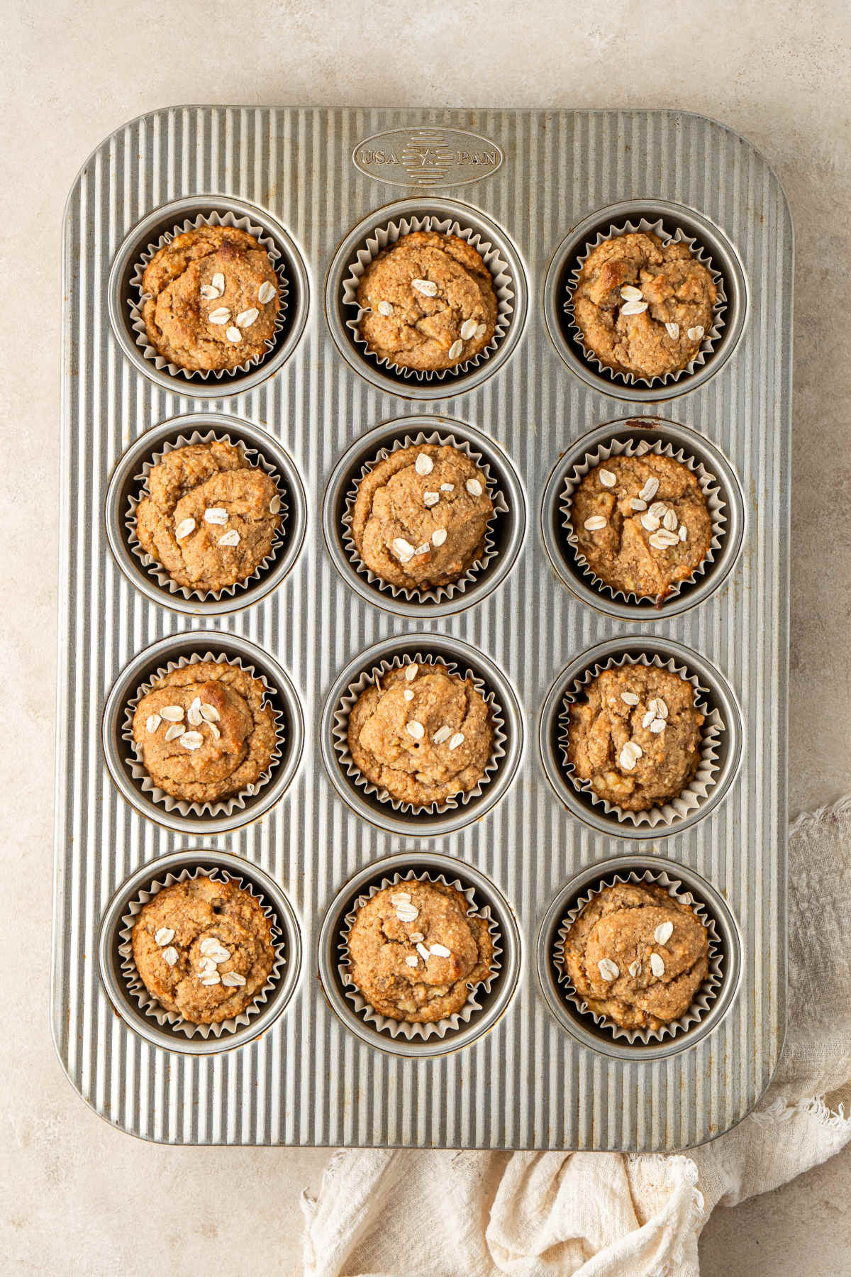 The muffin tray filled with now baked muffins.