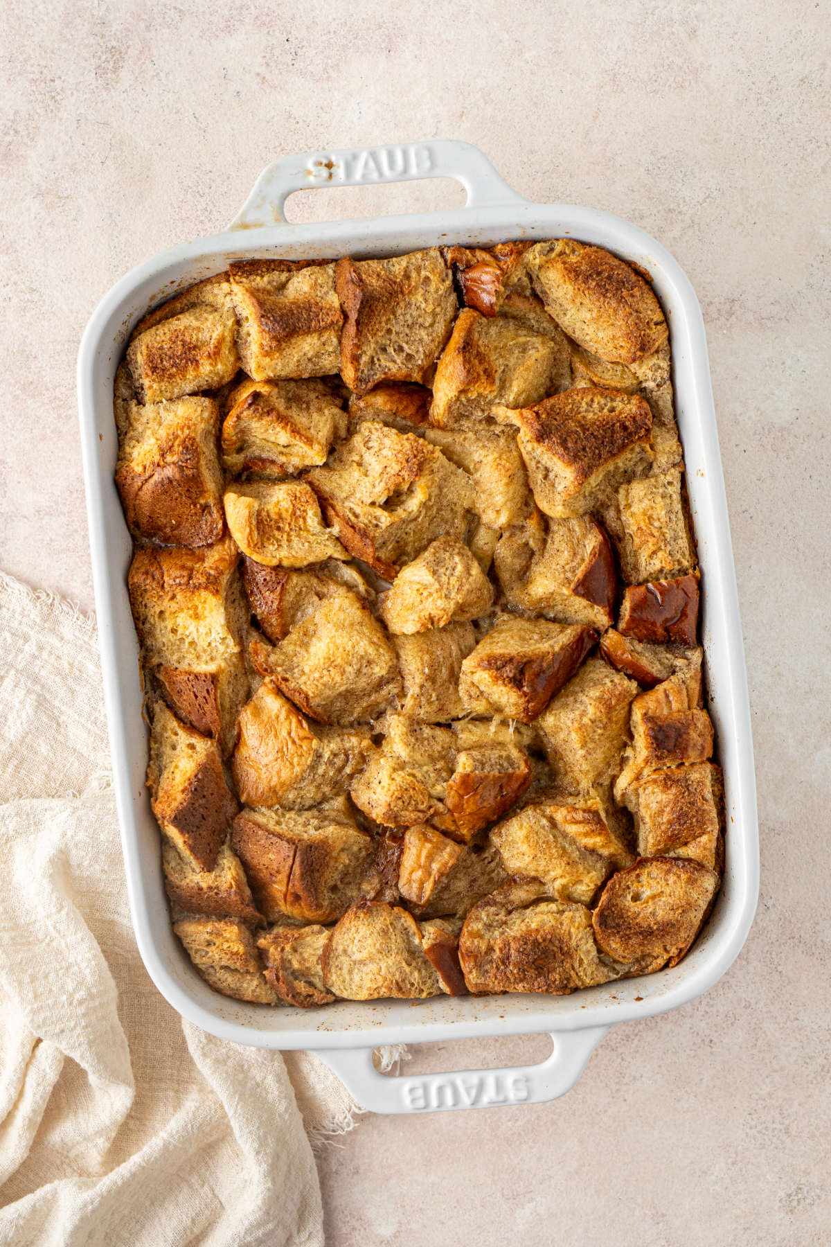 A baking dish straight out of the oven containing the French toast.