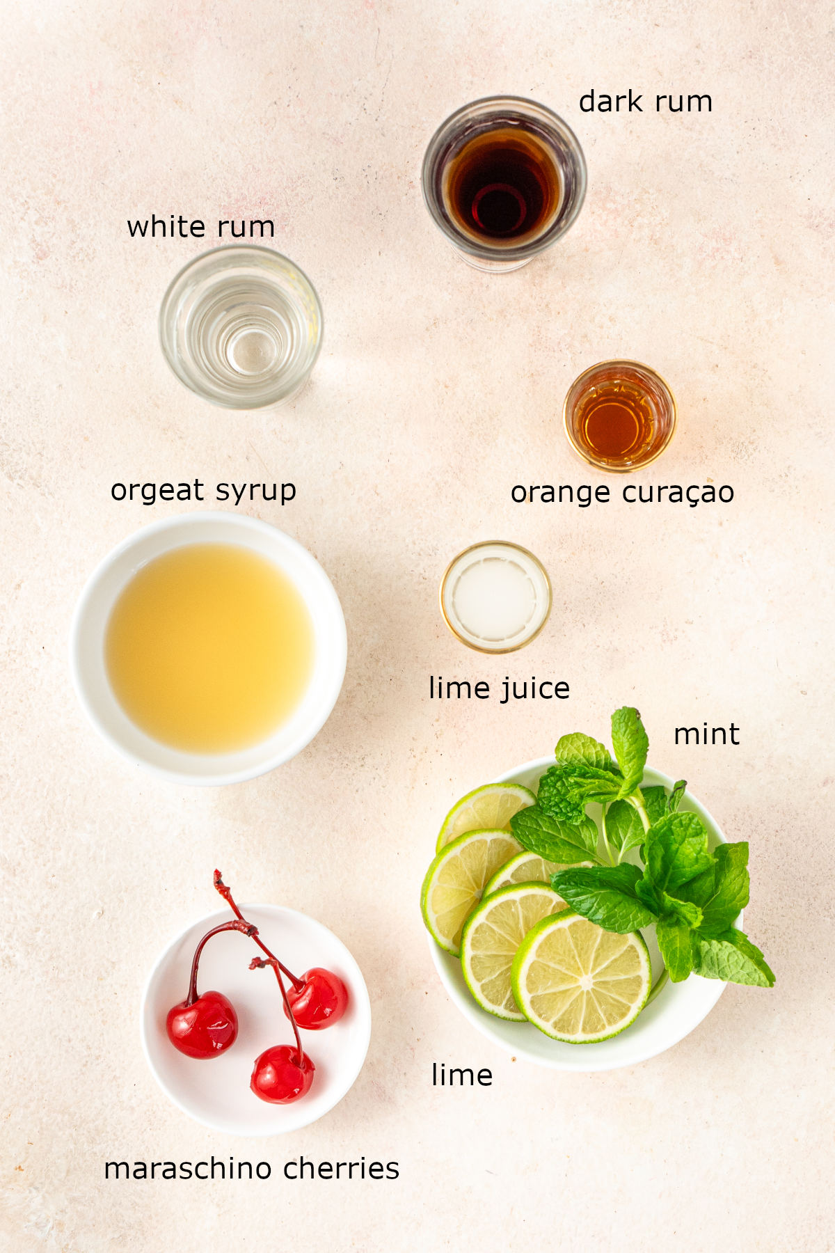 The ingredients for our cocktail laid out, labelled and portioned on a kitchen counter.