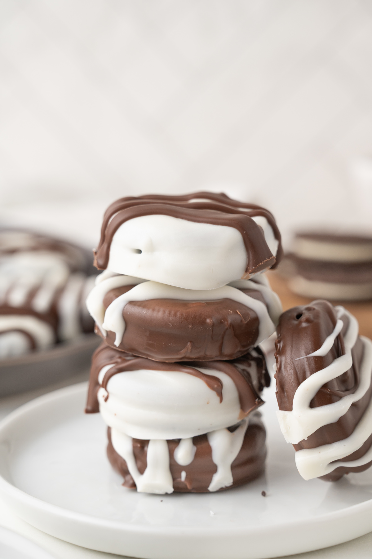 A stack of the snacks sitting on a plate, alternating dip colors.