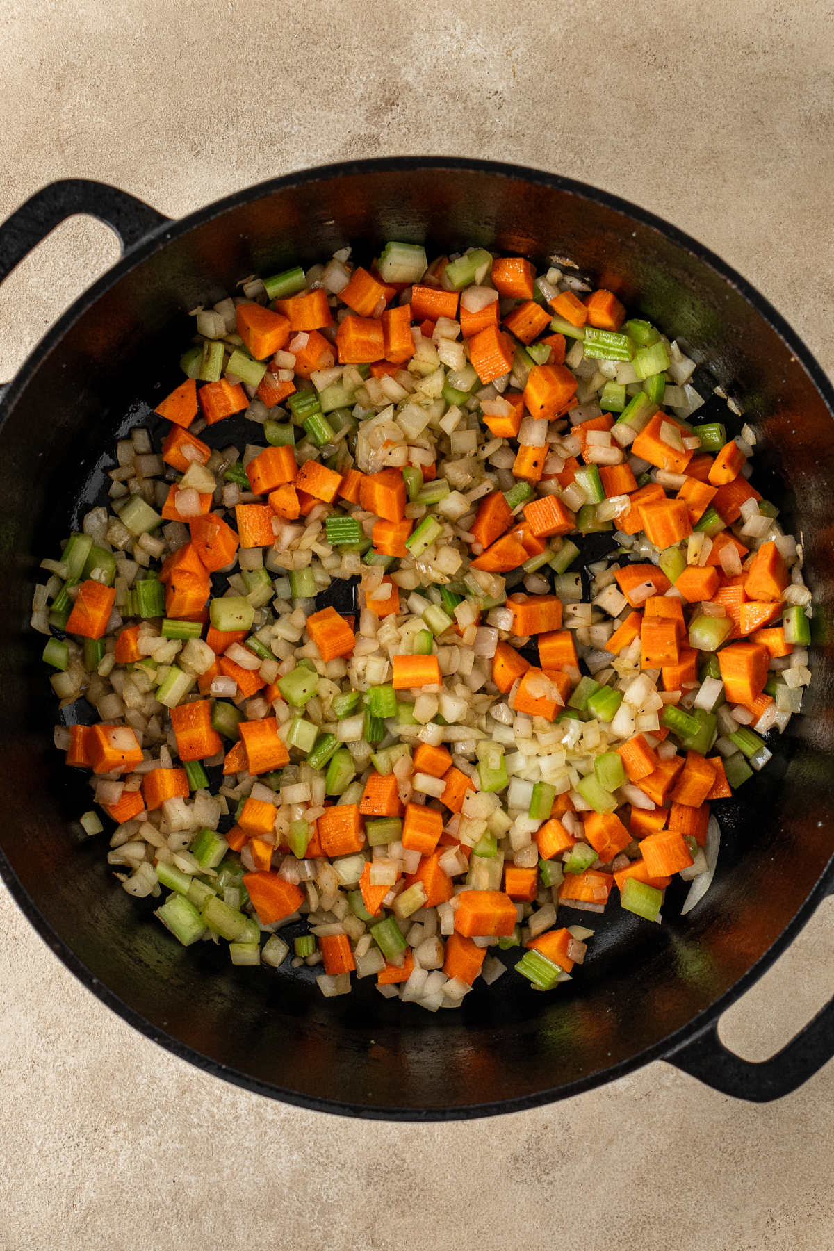 A pot of cooked mirepoix (carrots, onion, celery).